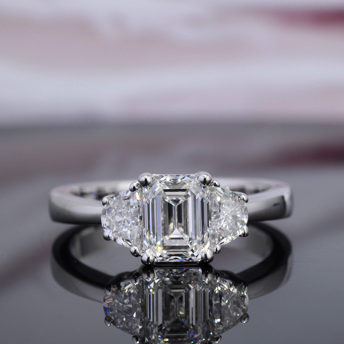 3 stone emerald cut & half moon diamond ring front