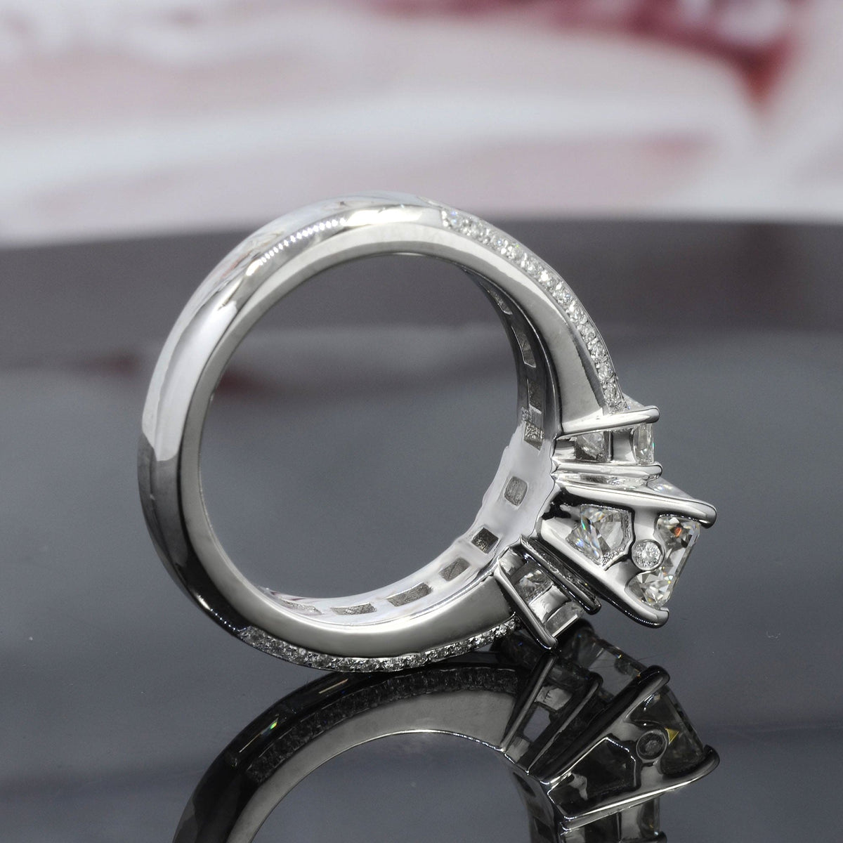 Emerald cut engagement ring with baguettes profile view