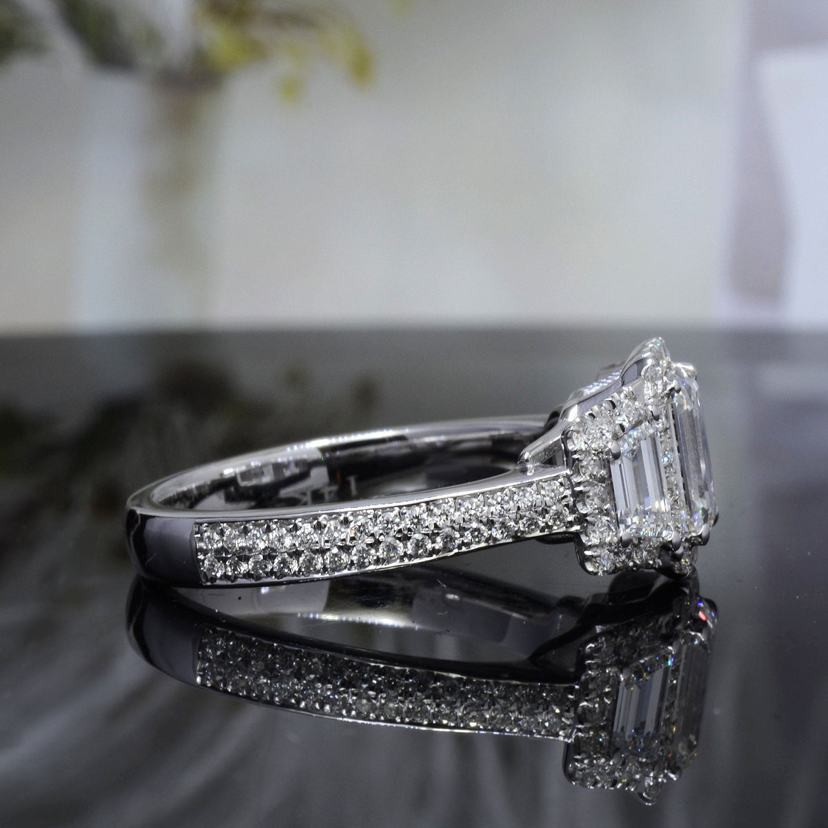 Halo emerald cut & trapezoids diamond ring side profile