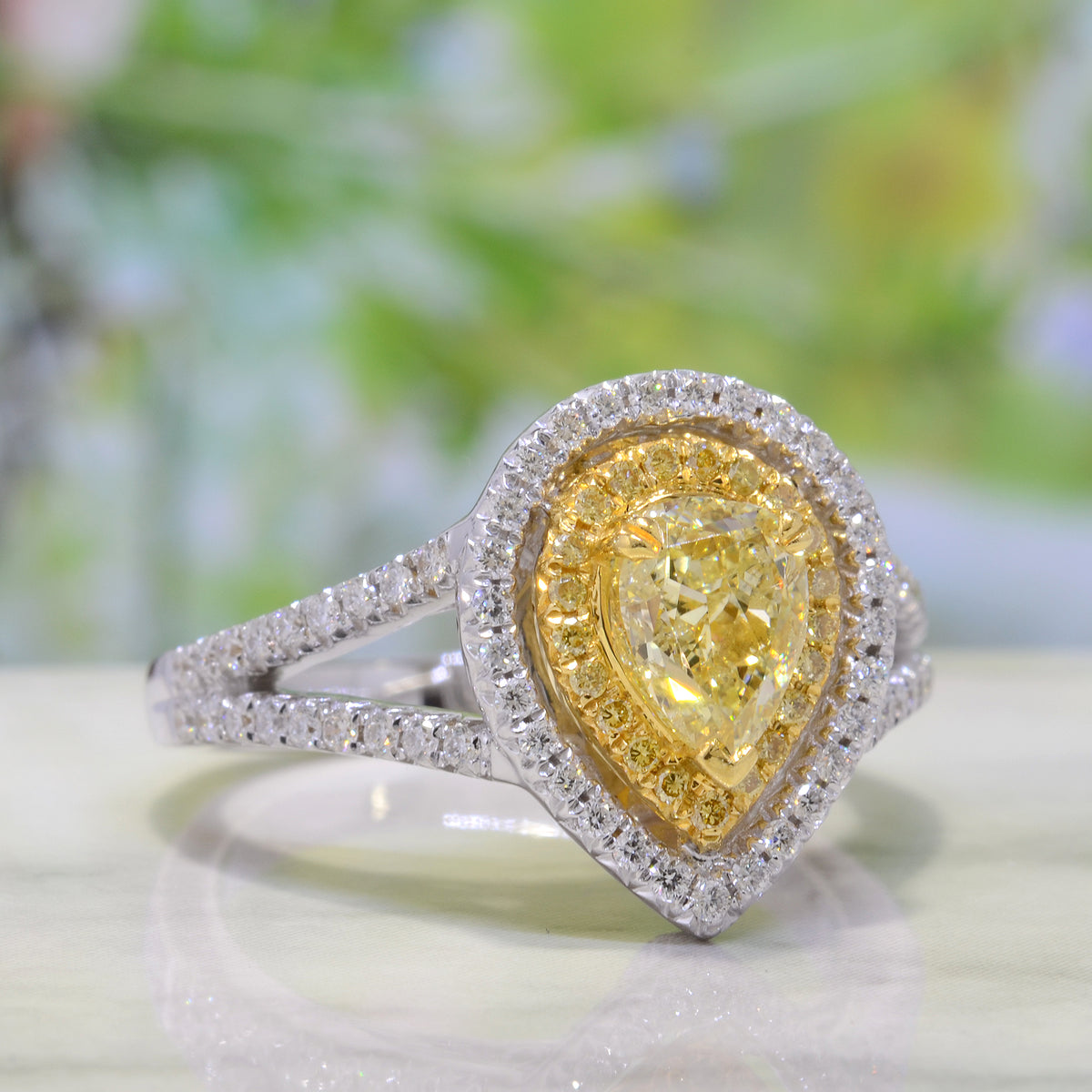 Pear shaped fancy yellow halo engagement ring