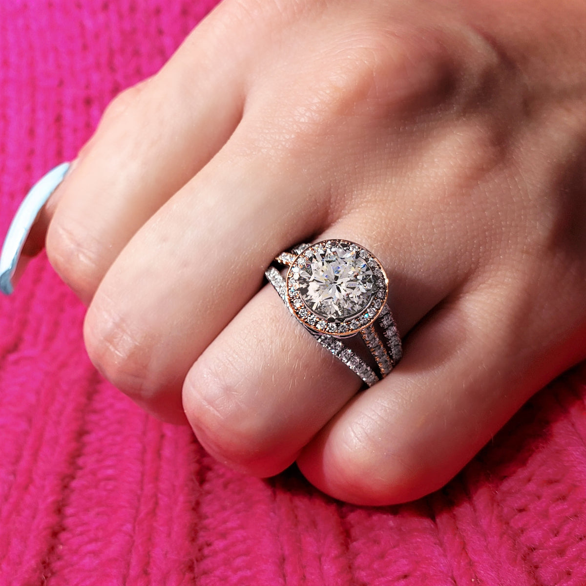 Natural_round_halo_two_toned_white_rose_gold_split_shank_unique_engagement_ring_hand_shot_0de85cdb f4ea 4730 98bf 1ca1b79f2e12