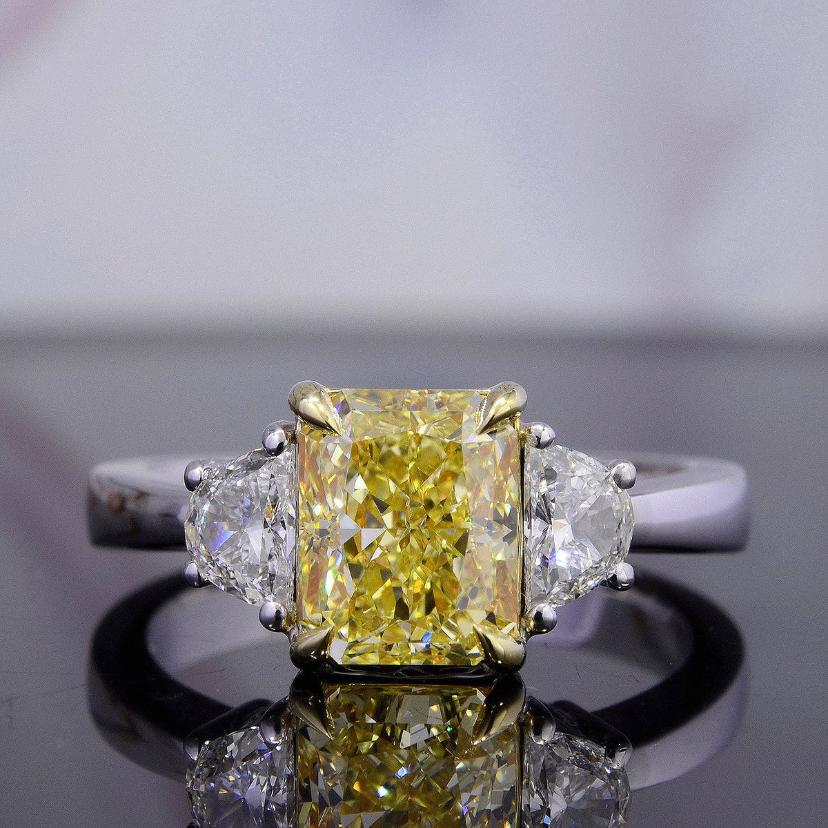 Fancy yellow canary radiant cut half moon diamond ring