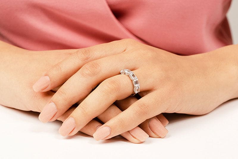 Emerald cut half eternity band with pave profile on finger