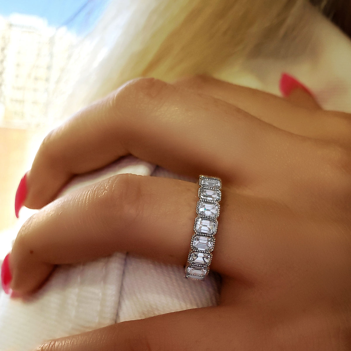 Vintage emerald eternity band on finger