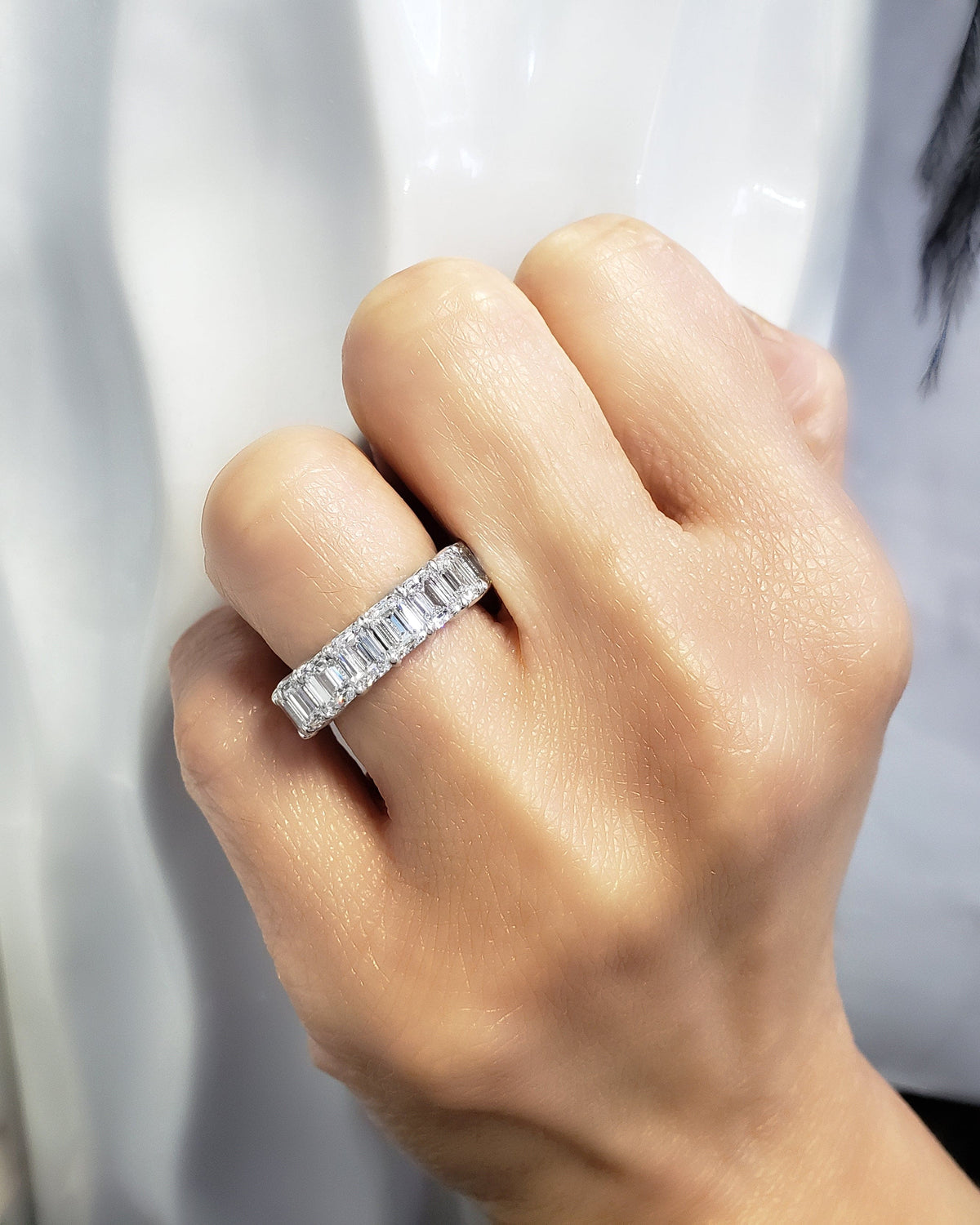 Emerald cut eternity ring on hand