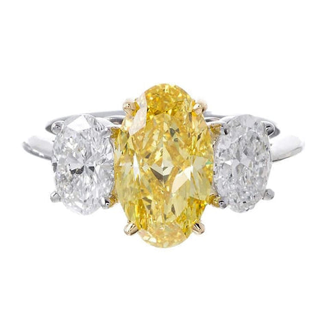 fancy yellow oval cut diamond three stone ring