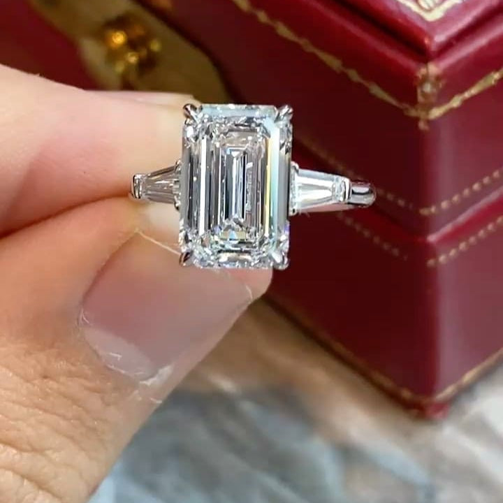Three Stone Emerald Cut Diamond Ring with baguettes on the sides on Hand