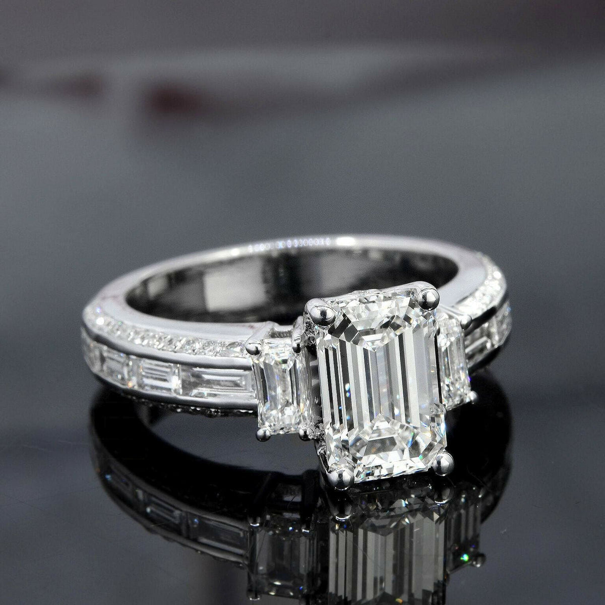 Emerald cut 3 stone diamond ring