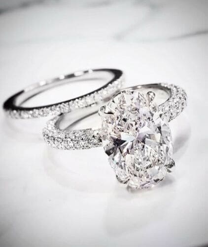 Hidden halo oval engagement ring set
